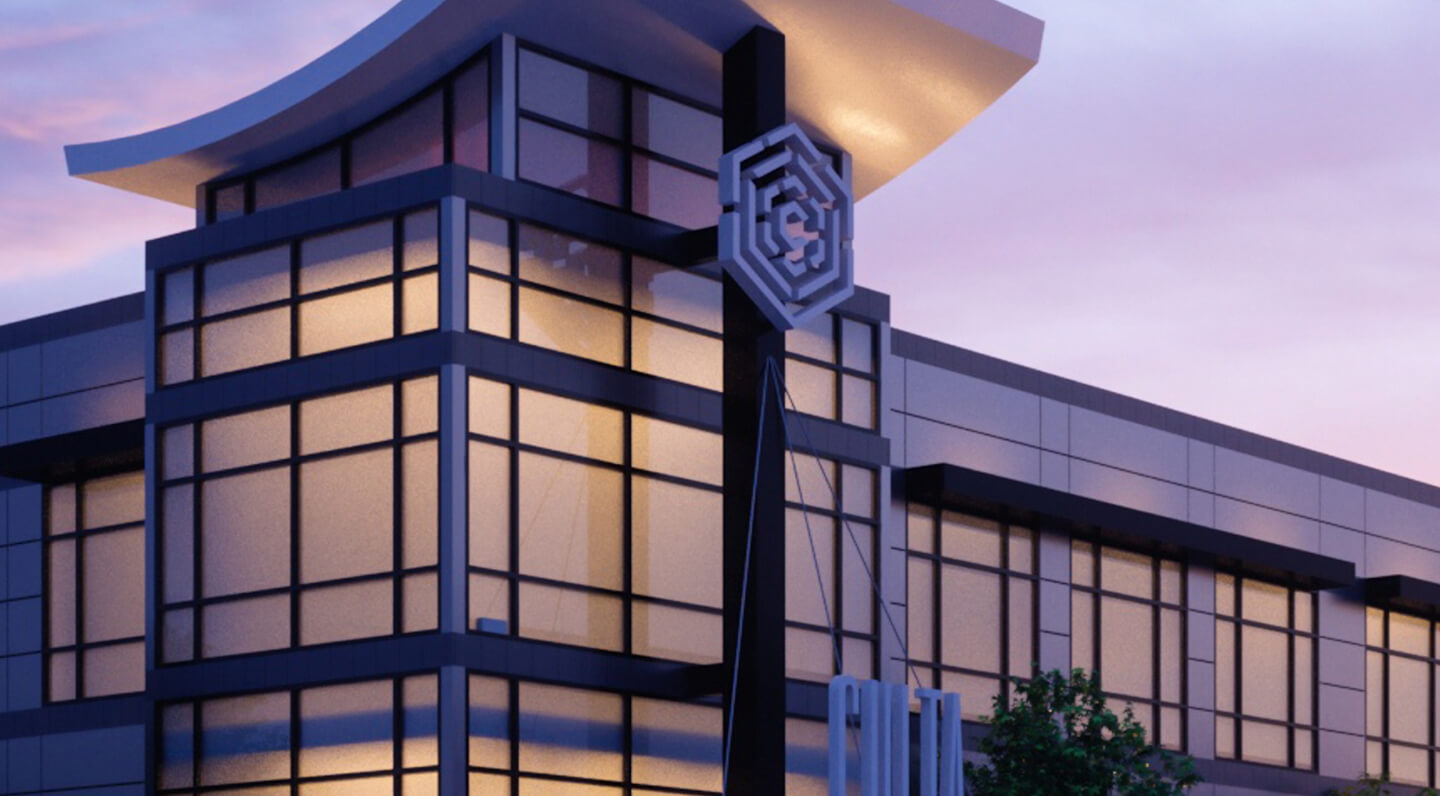 A modern office building with large glass windows and a sleek black and white design, featuring a geometric logo on a tall structure in front